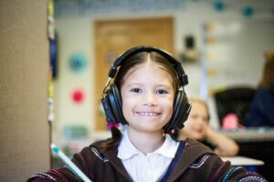 girl wearing black headphones, back to school