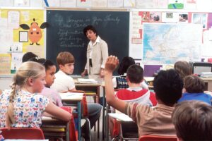 woman standing in front of children, back to school